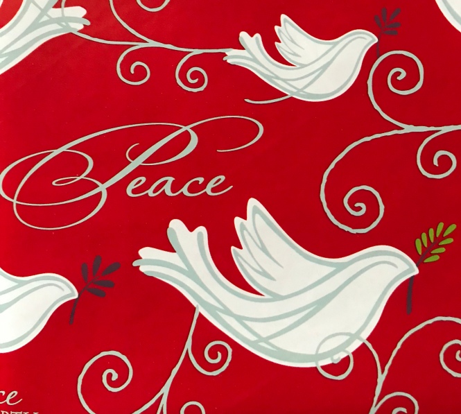 Red background with the word “peace” in cursive writing and sketches of doves with olive branches in their beaks.